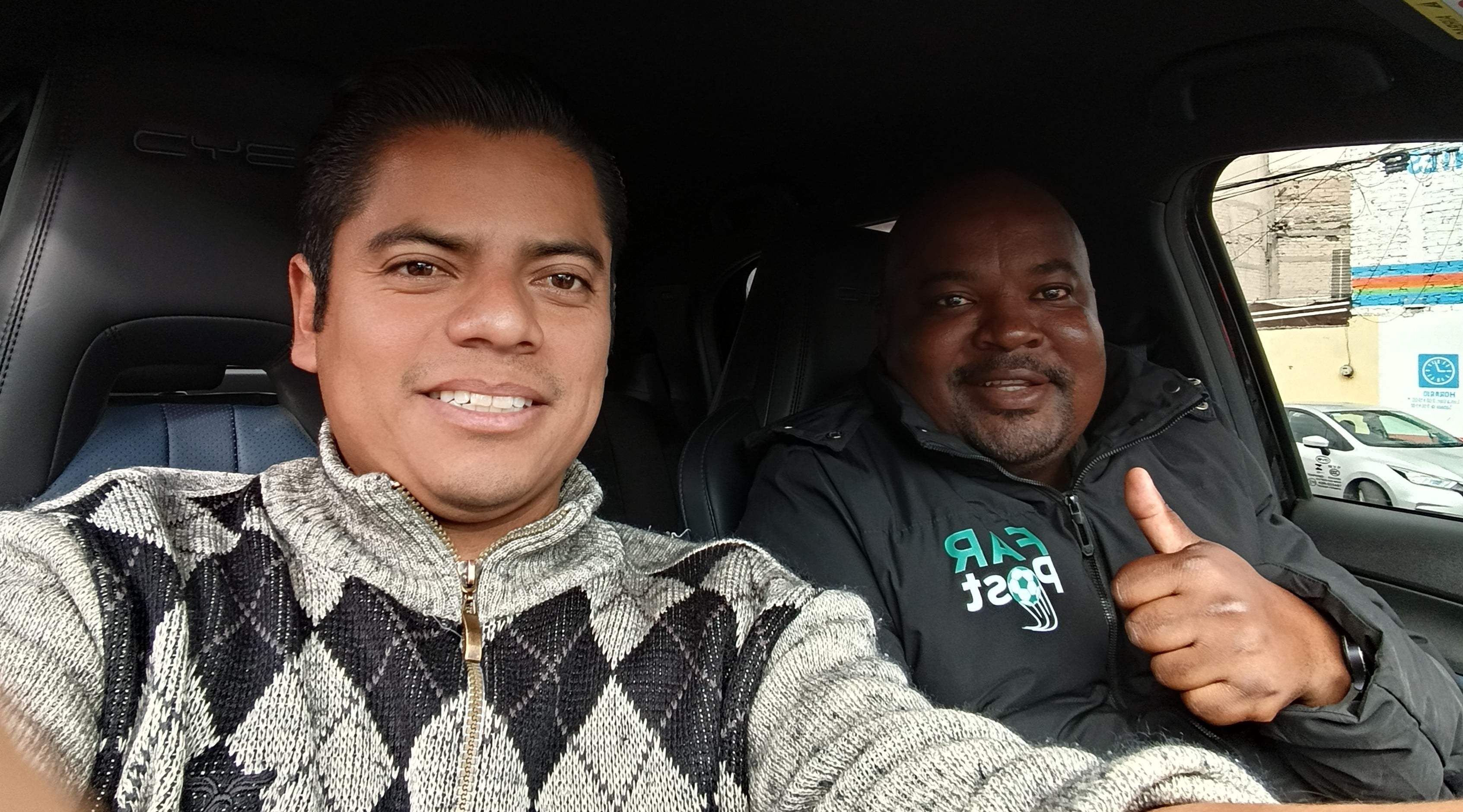 Oscar Gomez and Ofhani Munyai driving in the streets of Mexico.