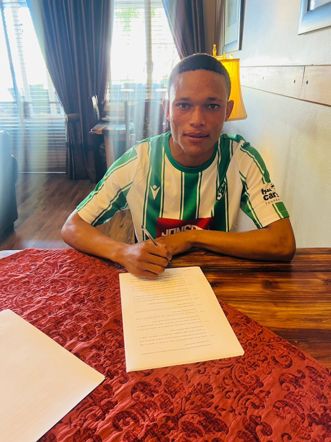 Sheldon Tebogo Mashuge signing his contract at Siwelele FC