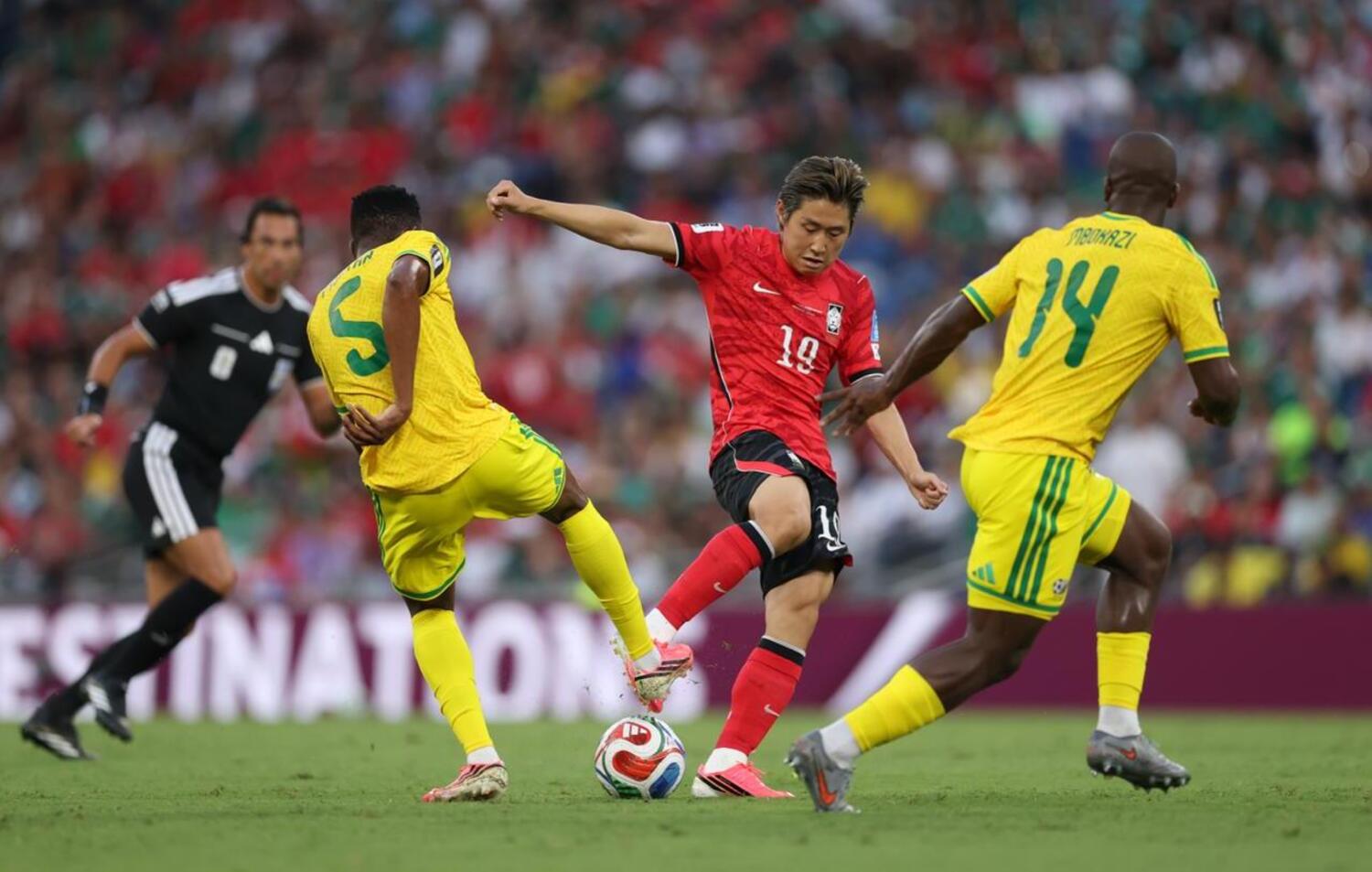 Bafana Bafana stars Thalente Mbatha and Mbekezeli Mbokazi try to stop Lee Kang-In of South Korea