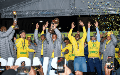 Themba Zwane lifts the CAF Champions League celebrating alongside Ronwen Williams and other Mamelodi Sundowns players