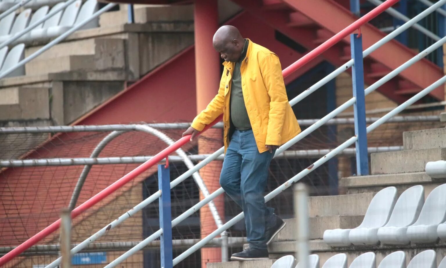Black Leopards president David Thidiela walking down from the stadium stands.
