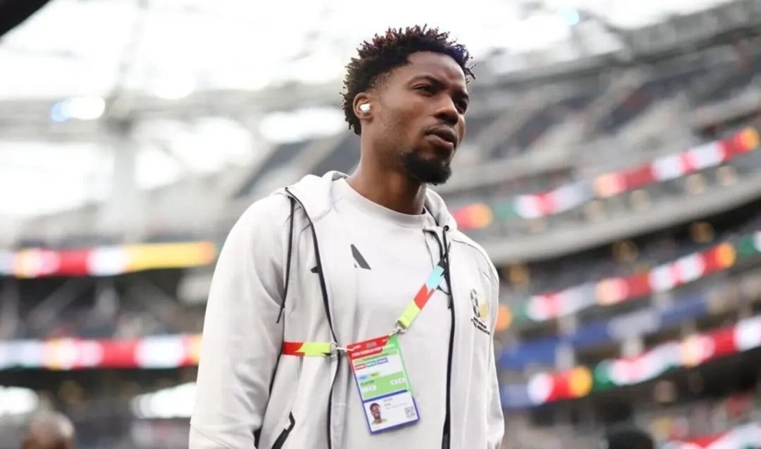 Ime Okon walking during a pitch inspection at the 2026 FIFA World Cup.