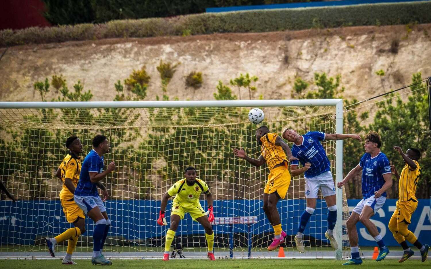 Kaizer Chiefs defender Inacio Miguel in an aerial challenge against Rangers FC while supported Given Msimango and Paseka Mako
