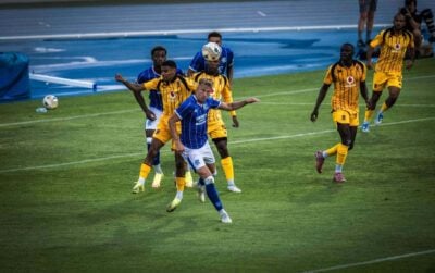 Kaizer Chiefs defender Dillan Solomons in an areal challenge with a Rangers FC player as Thabo Moloisane, Flavio da Silva and Reeve Frosler back up during a pre-season friendly match in Spain