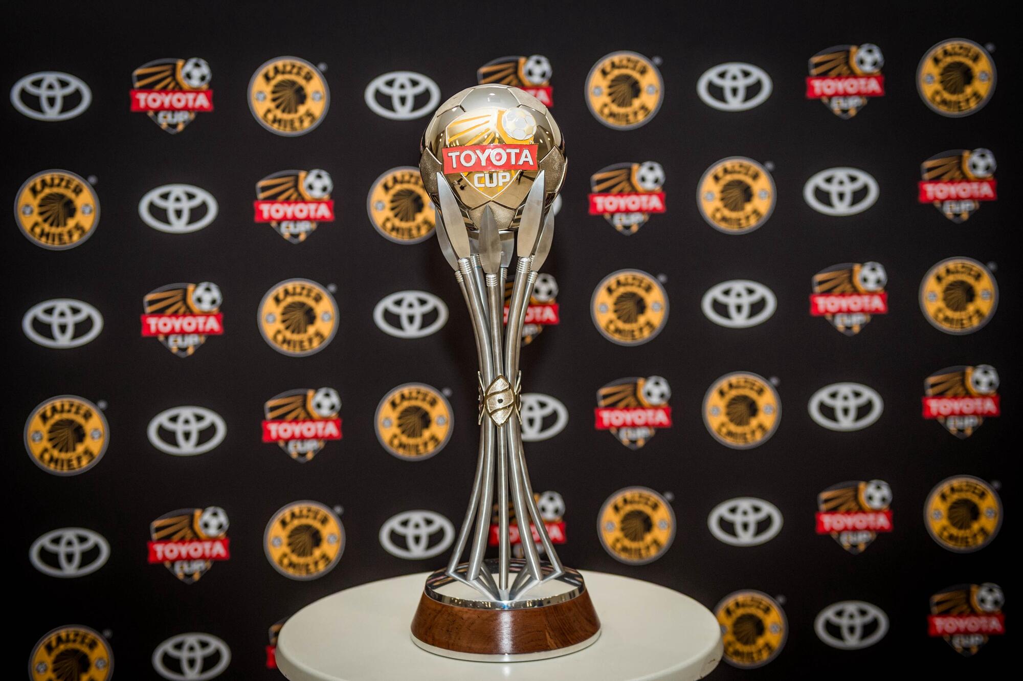 The Toyota Cup Trophy displayed in front of a Kaizer Chiefs banner