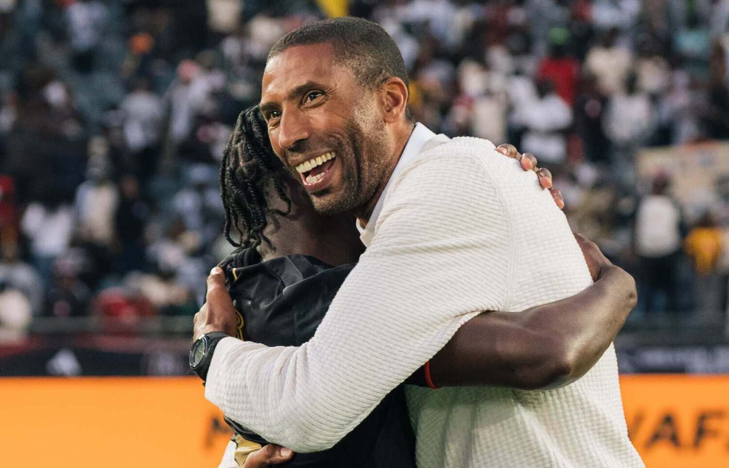 Abdeslam Ouaddou embracing Gamphani Lungu after Orlando Pirates beat Durban City