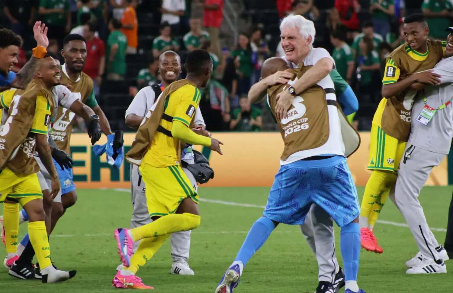Bafana Bafana players embrace coach Hugo Broos celebrating beating South Korea at the 2026 FIFA World Cup