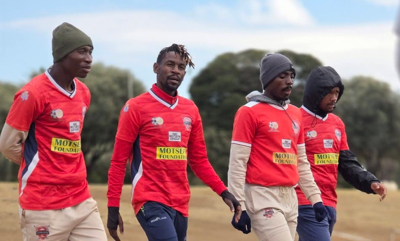 Lebogang Mabotja walking with Gomora United players during a training session.