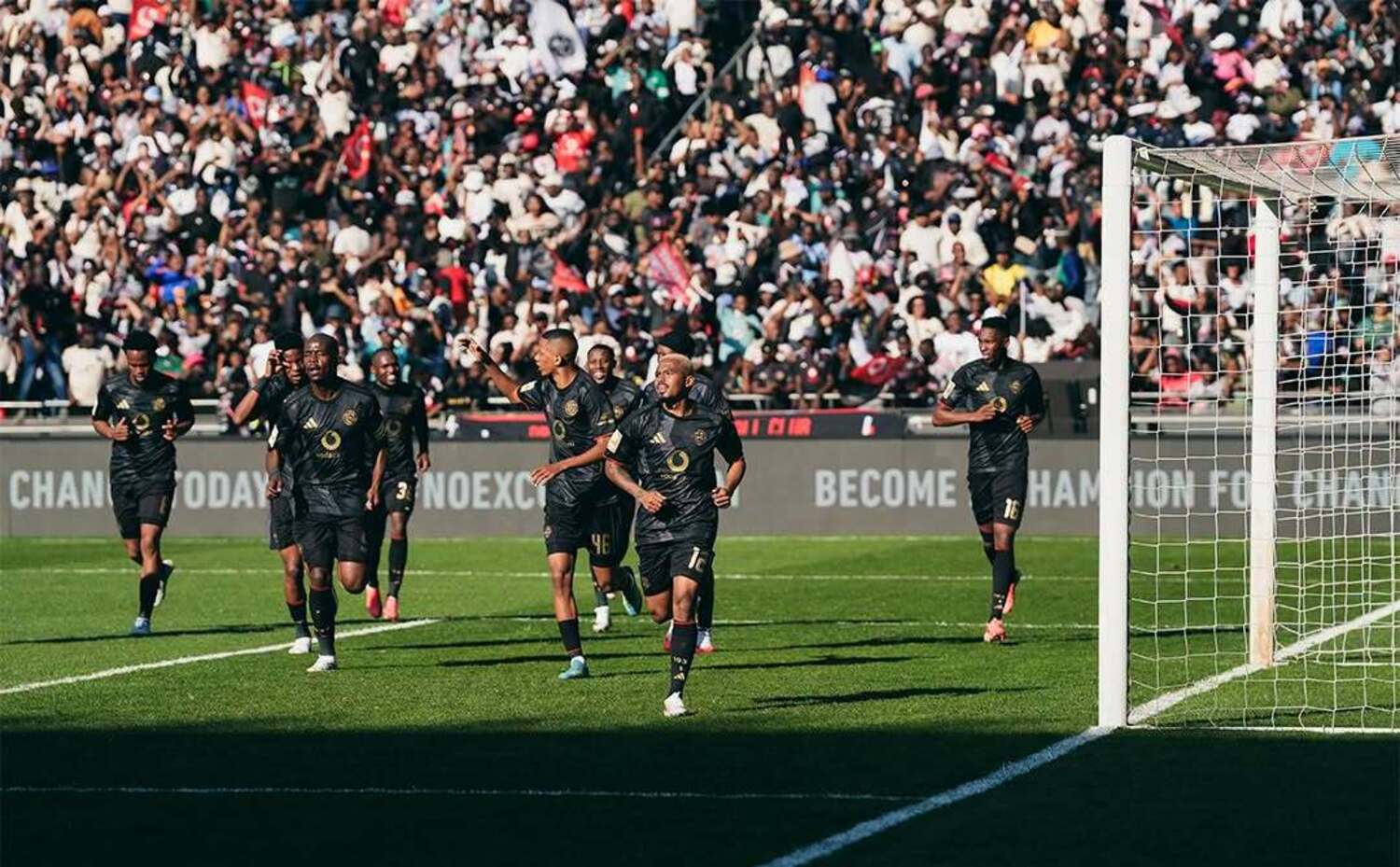 Oswin Appollis lead Orlando Pirates players in celebrating after scoring