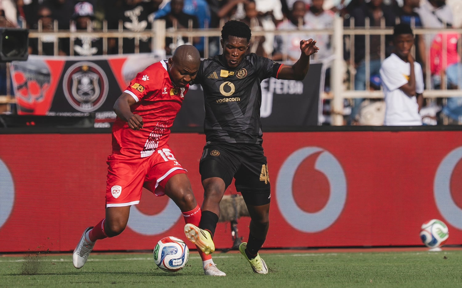 Siphesihle Mkhize of Sekhukhune United shields the ball away from Orlando Pirates' Simphiwe Masilela
