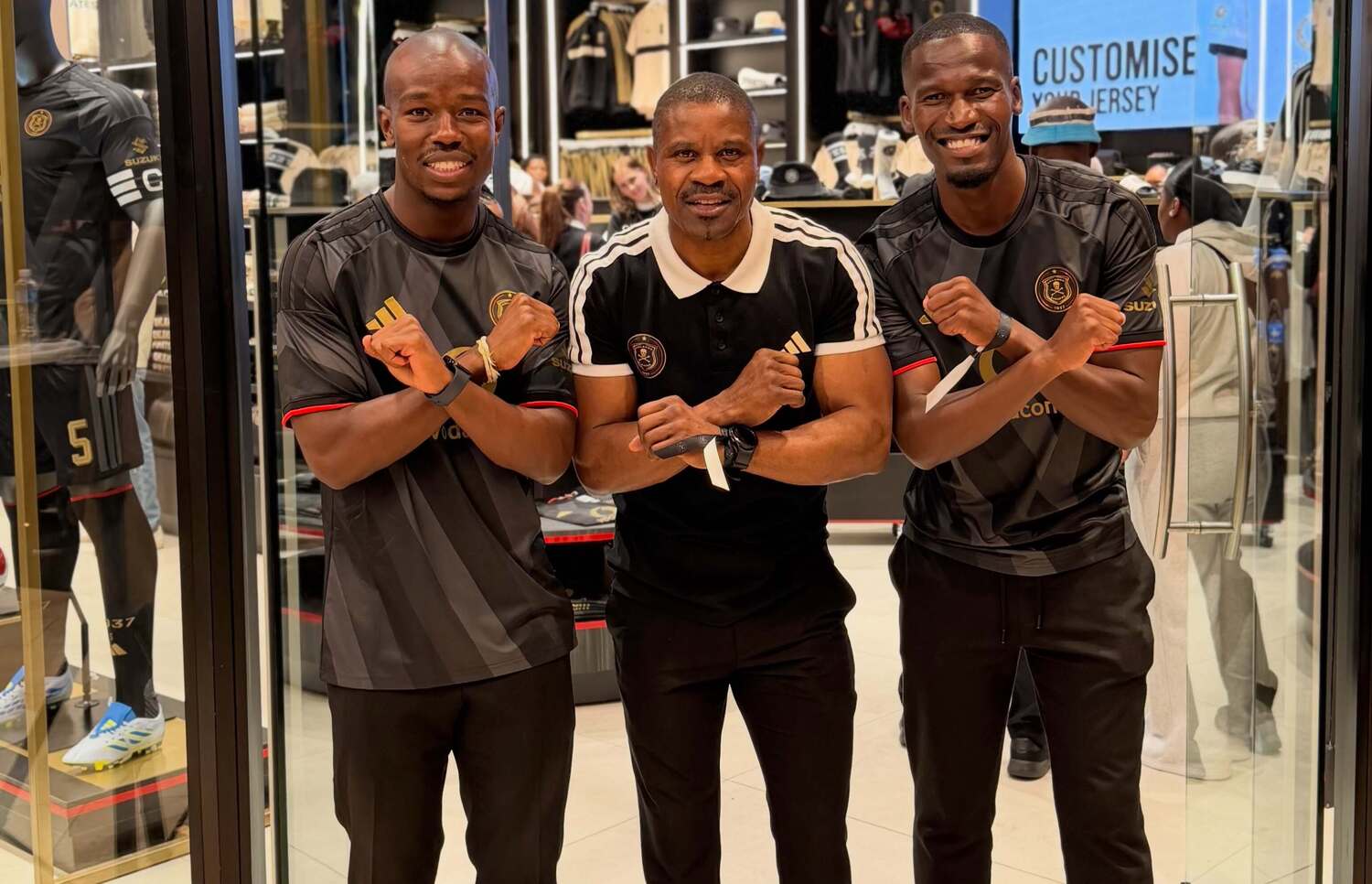 Nkosinathi Sibisi, Lucky Lekgwathi and Tapelo Xoki doing the Orlando Pirates crossbones pose