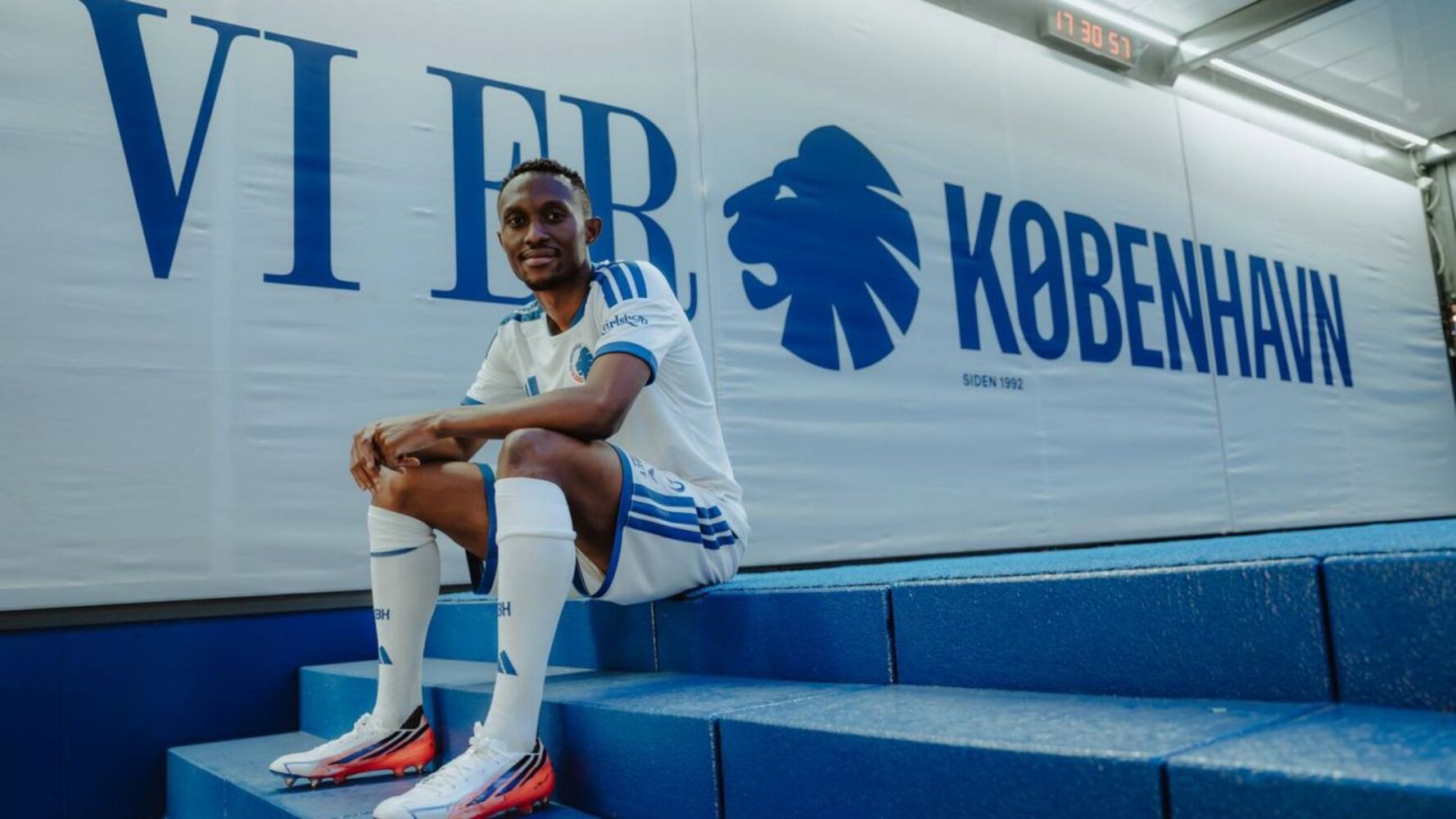 Thapelo Maseko sitting down in front of FC Copenhagen logo