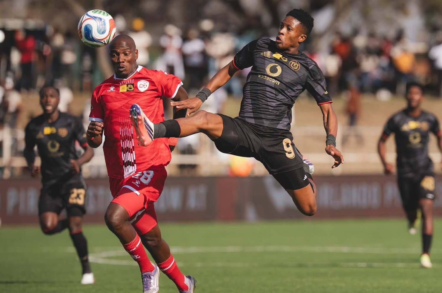 Orlando Pirates striker Yanela Mbuthuma tries to trap the ball under the challenge of Sekhukhune United's Tshepo Matsimbi