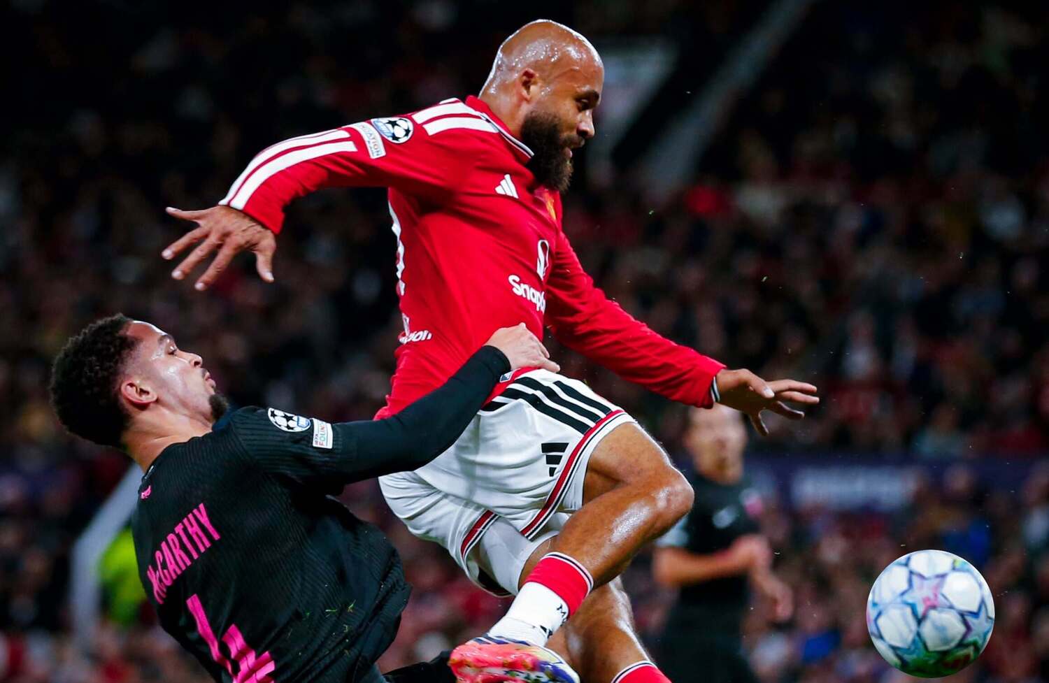 Aden McCarthy tackles Manchester United striker Bryan Mbeumo during a UEFA Champions League match at Old Trafford