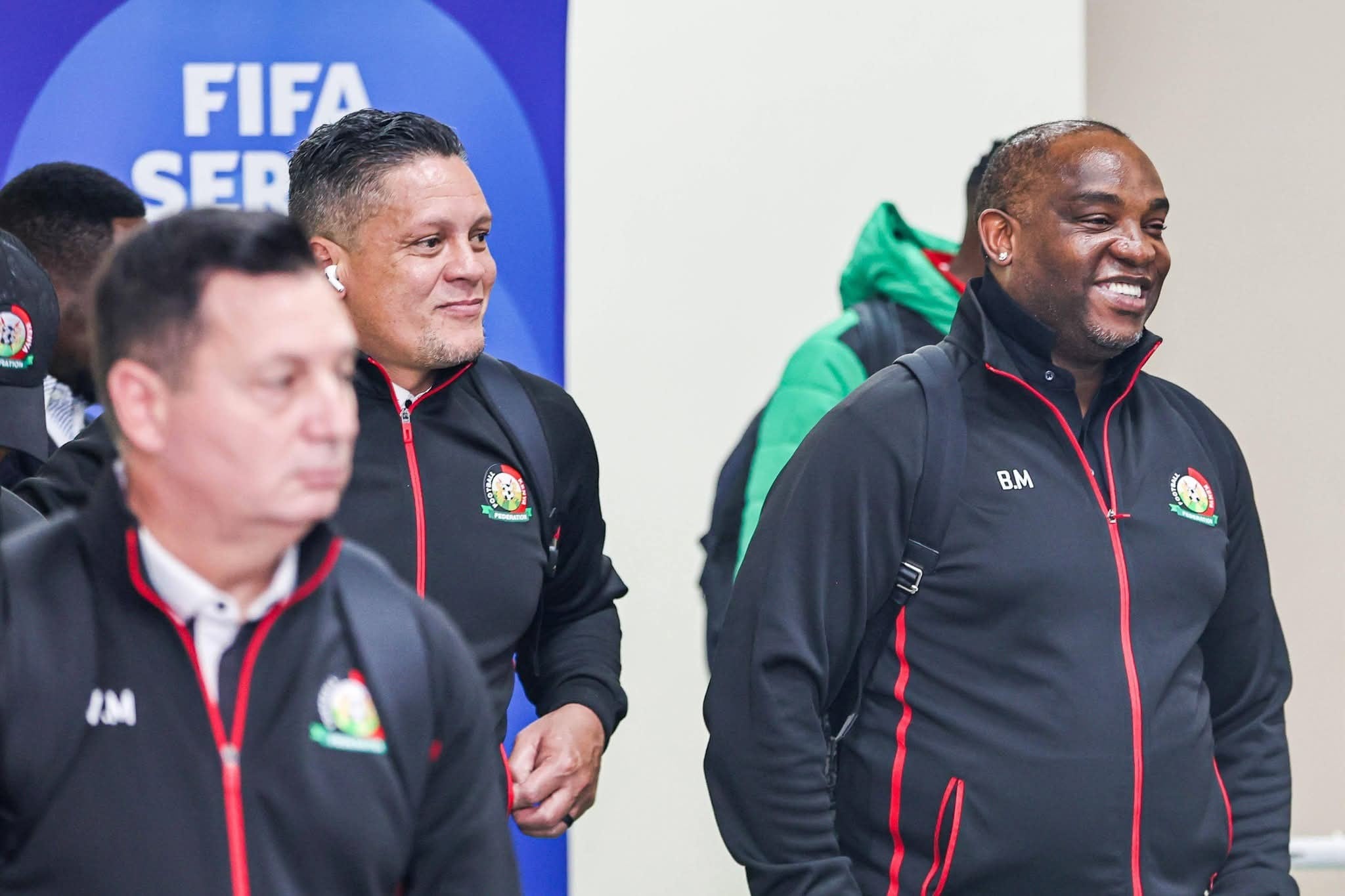 Benni McCarthy and Moeneeb Josephs smiling while traveling with the Harambee Stars.