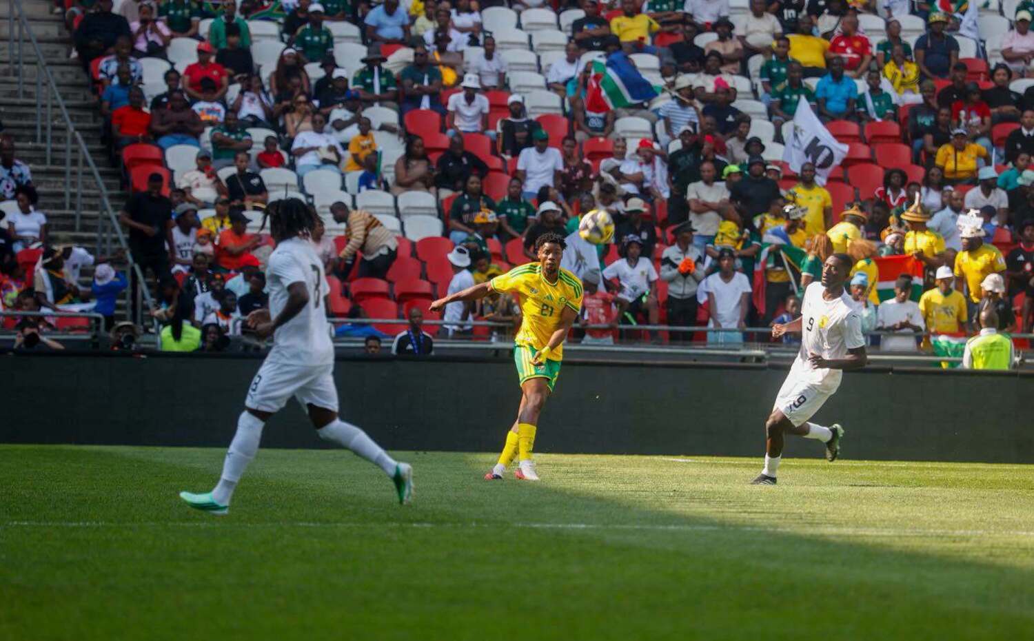 Ime Okon clears the ball under the challenge of Guinea players