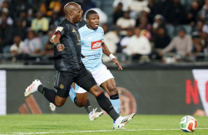 Orlando Pirates captain Nkosinathi Sibisi challenging Durban City FC striker Jean Lwamba