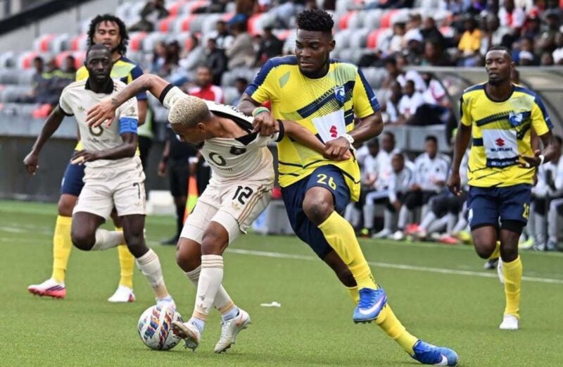 Oswin Appollis being pulled by a La Cure Waves player during a CAF Champions League encounter