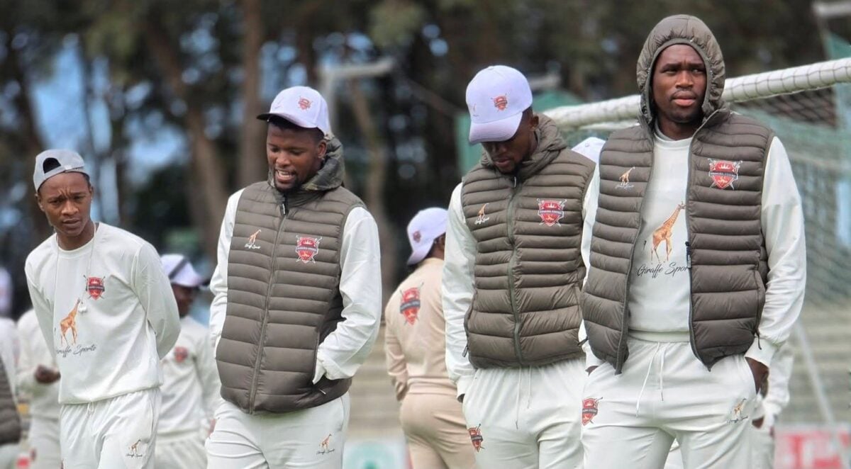 Gomora United players doing pitch inspection before a League match.