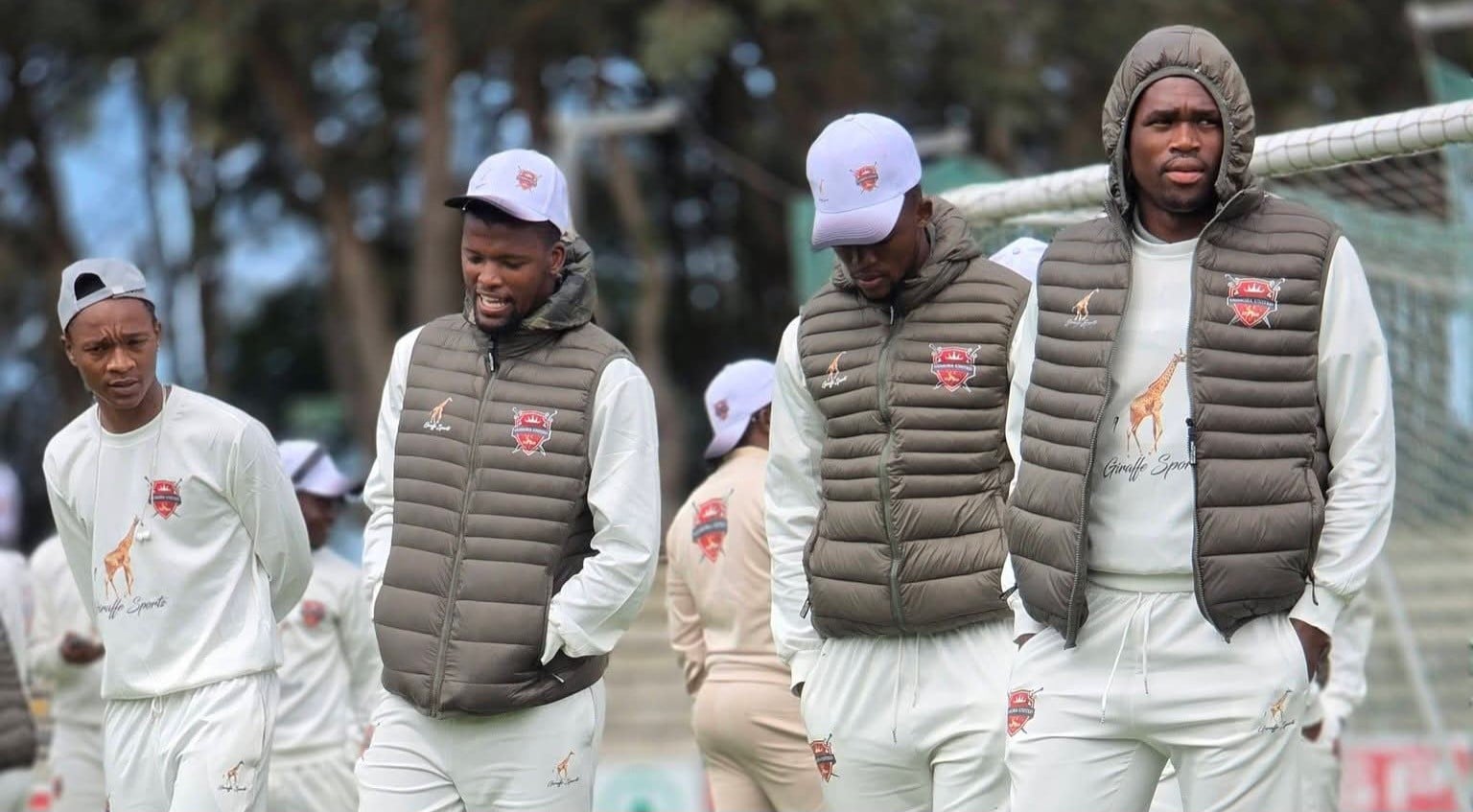 Gomora United players doing pitch inspection before a League match.