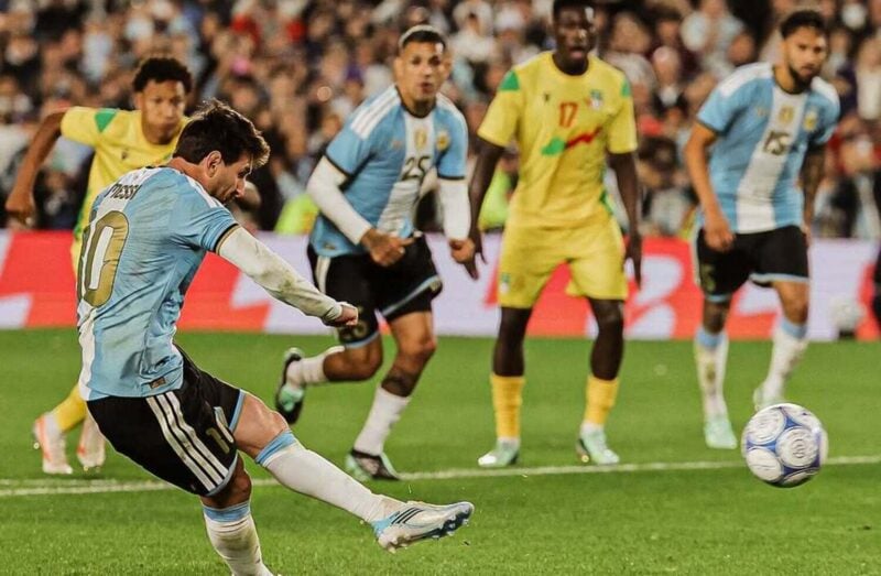 Lionel Messi taking a penalty against Benin and Kruger United goalkeeper Marcel Dandjinou