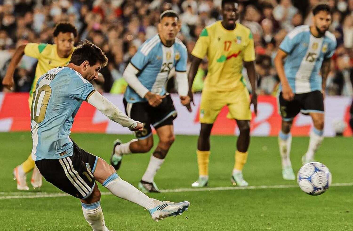 Lionel Messi taking a penalty against Benin and Kruger United goalkeeper Marcel Dandjinou