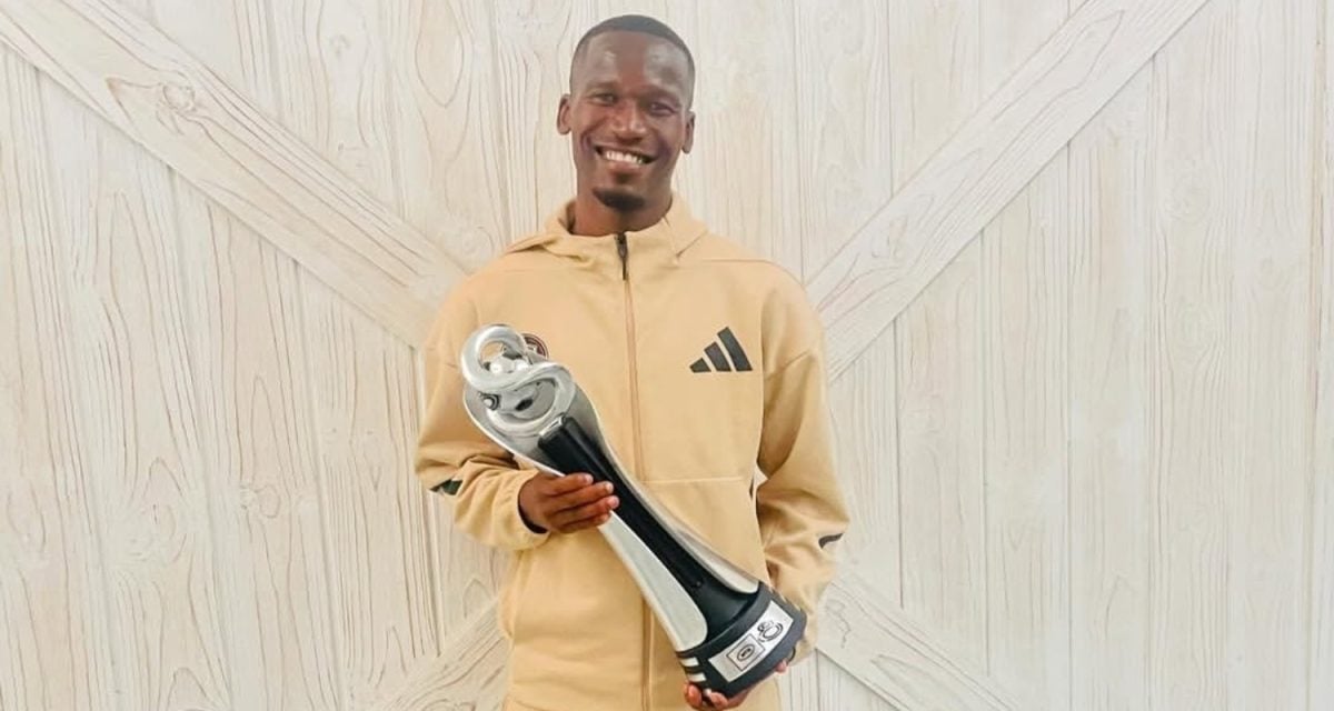 Orlando Pirates defender Tapelo Xoki holding the MTN8 trophy