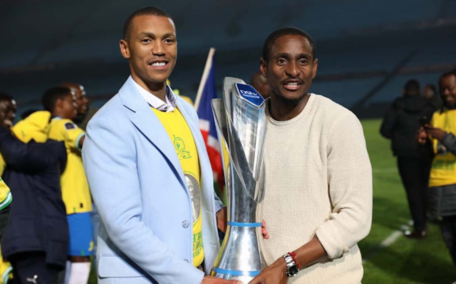 Tlhopie Motsepe and Rulani Mokwena hold Mamelodi Sundowns' PSL trophy
