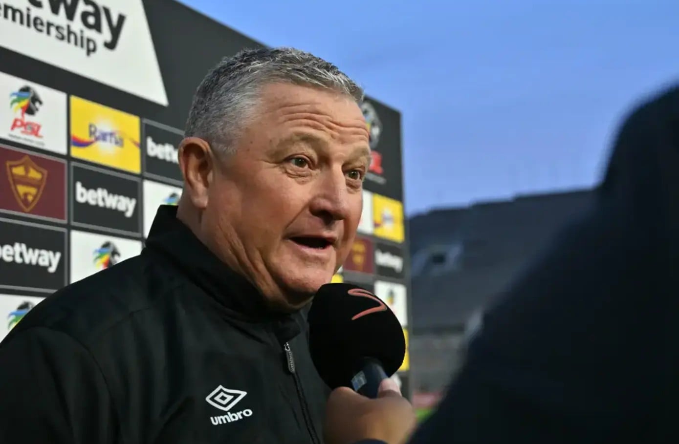 Gavin Hunt conducting an interview with SuperSport TV before a League match.
